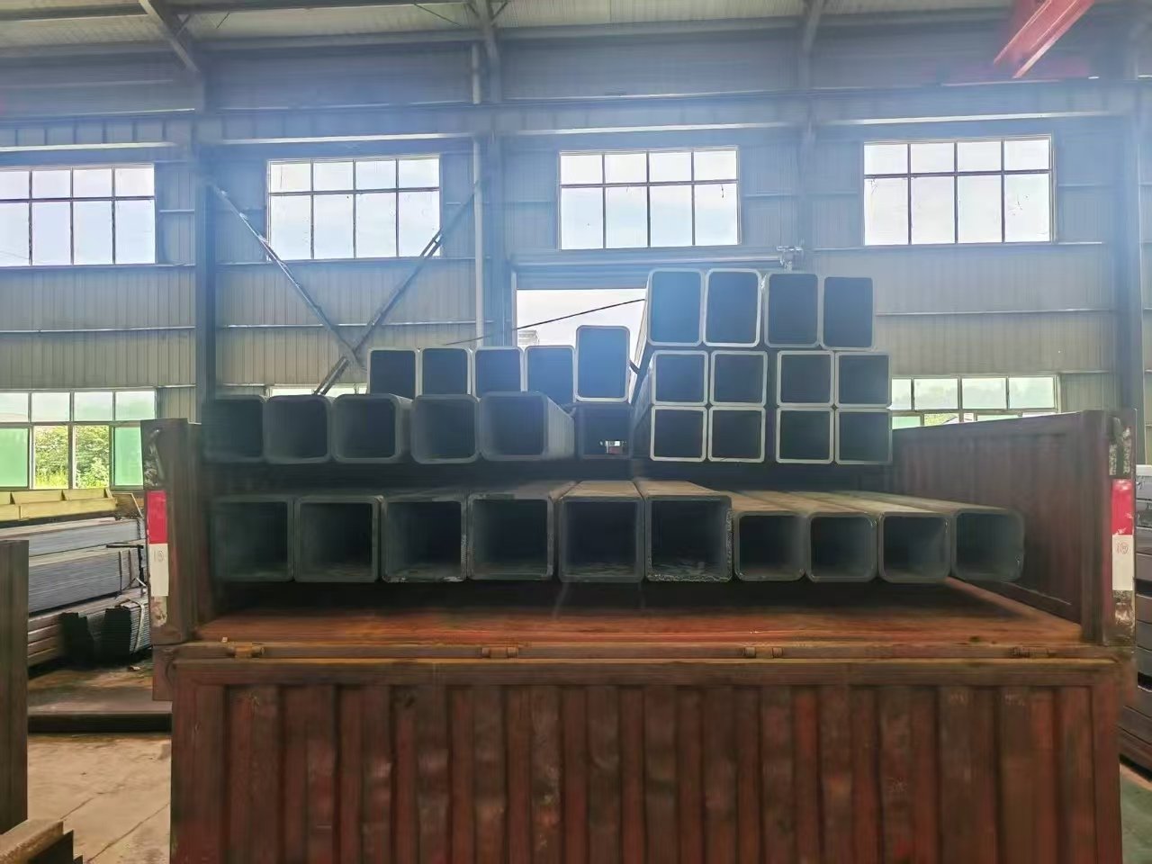 Export packing of steel products with protective strapping before container stuffing.