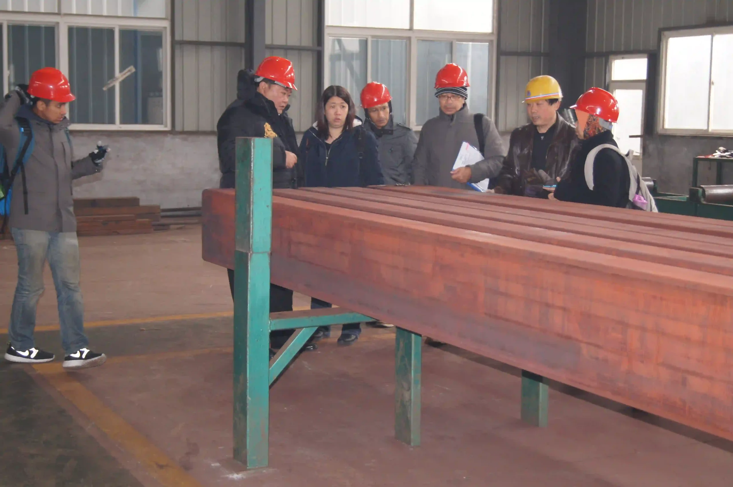 Customer measuring wall thickness of a rectangular steel tube during pre-shipment inspection.