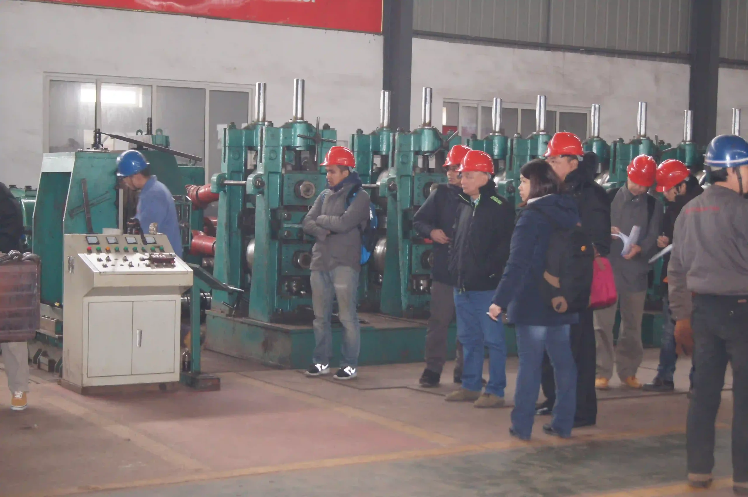 Overseas buyers reviewing steel tube stock in the finished goods warehouse.