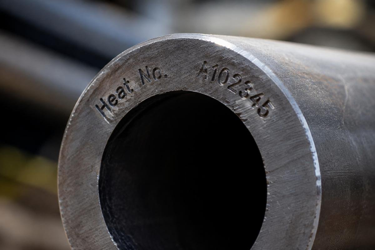 Close-up of steel pipe end showing clear heat number stamping and surface texture for traceability verification