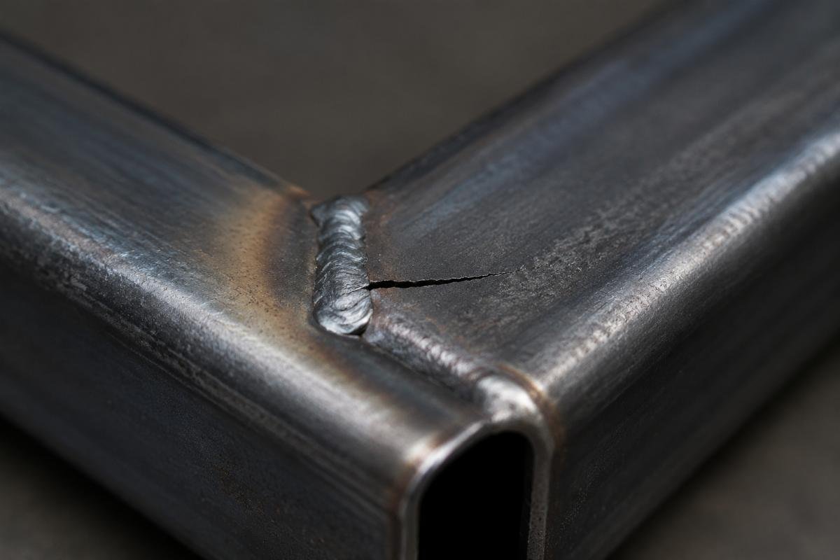 Close-up of weld crack in cold-formed tube corner due to residual stress